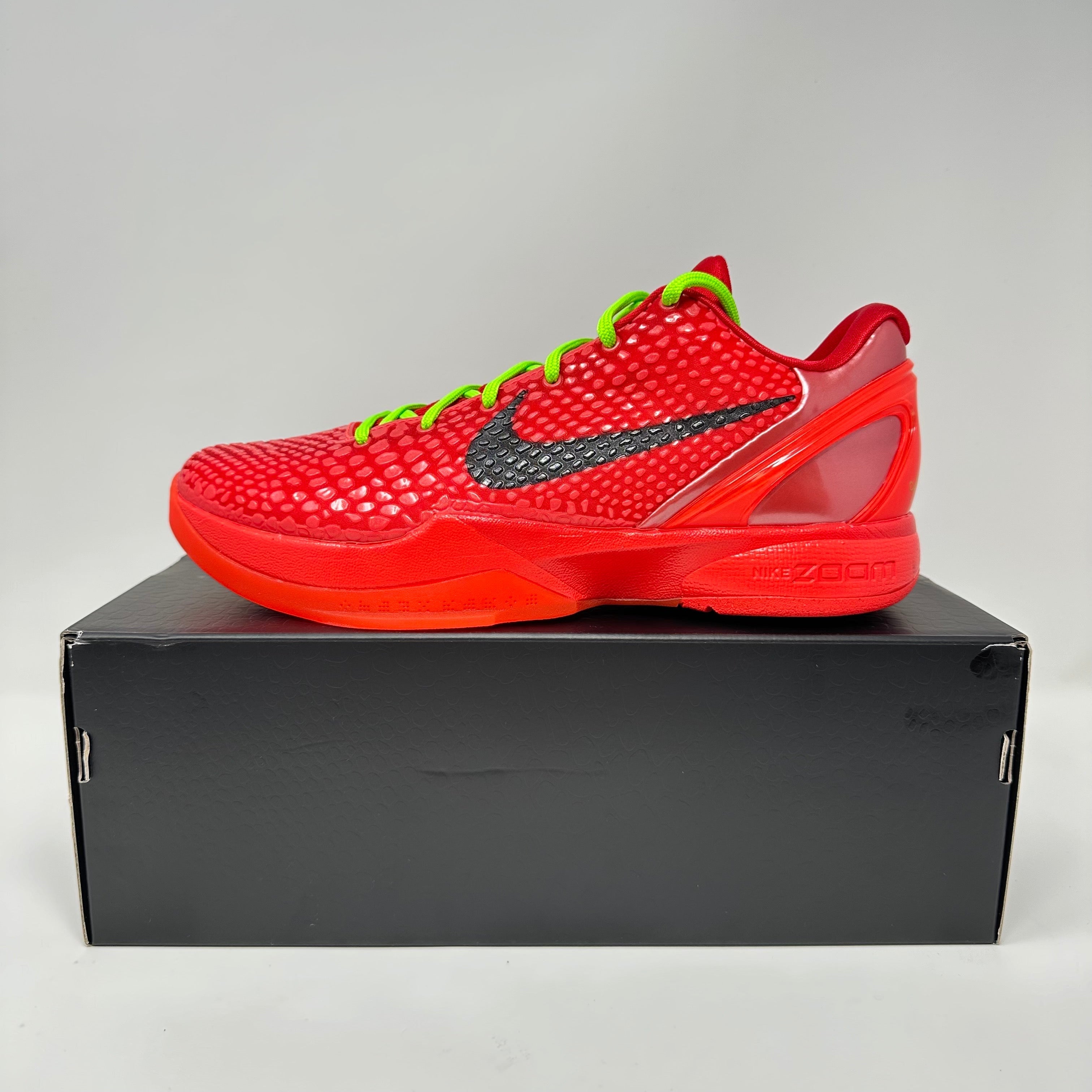 Nike Kobe 6 Protro Reverse Grinch basketball shoe in vibrant red with green laces and black Nike swoosh on black box