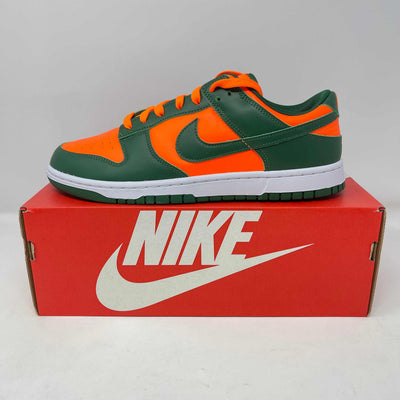 Nike Dunk Low sneaker with orange and dark green leather panels, matching swoosh, white midsole, and green outsole.