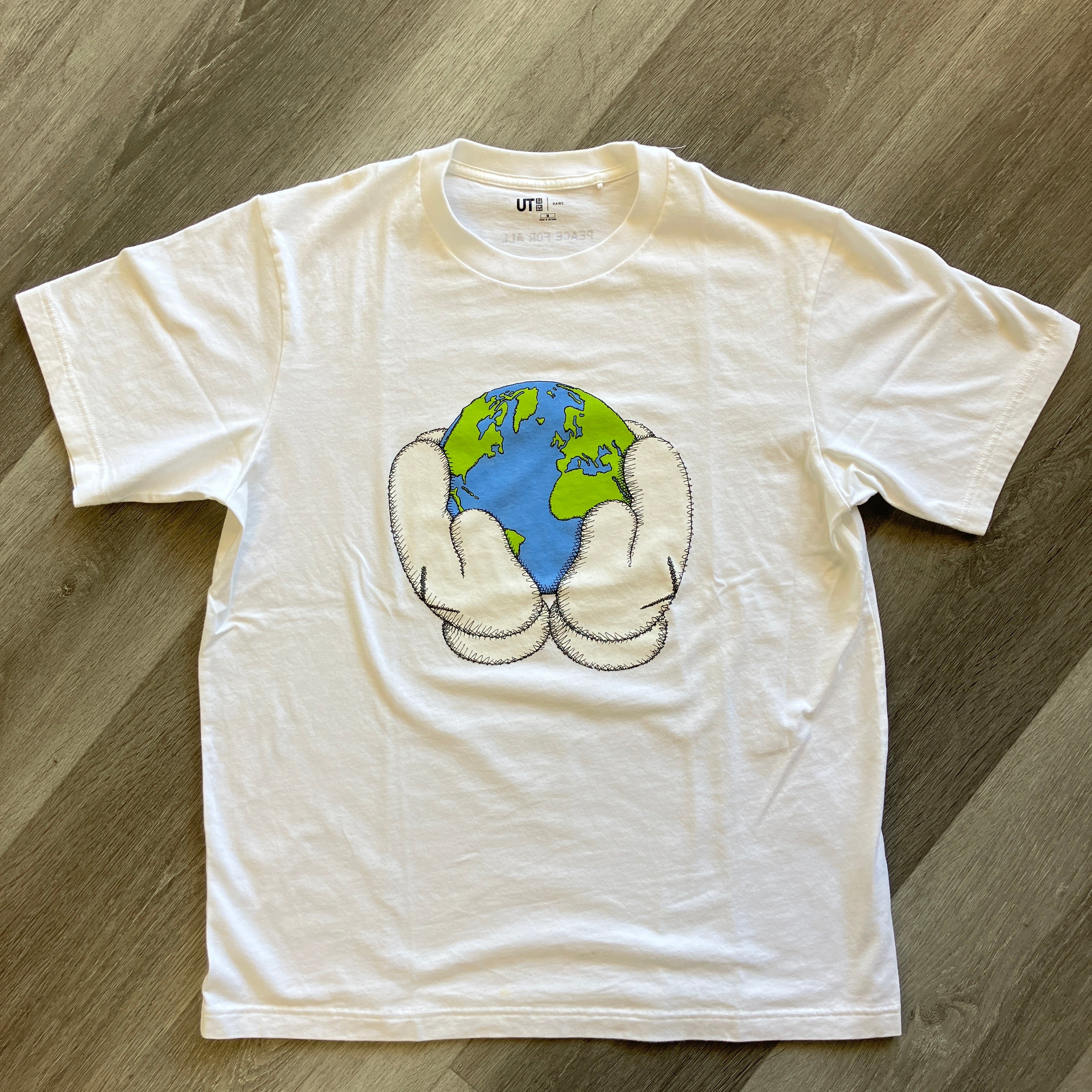 KAWS x Uniqlo white graphic t-shirt with Peace For All design holding globe, pre-owned