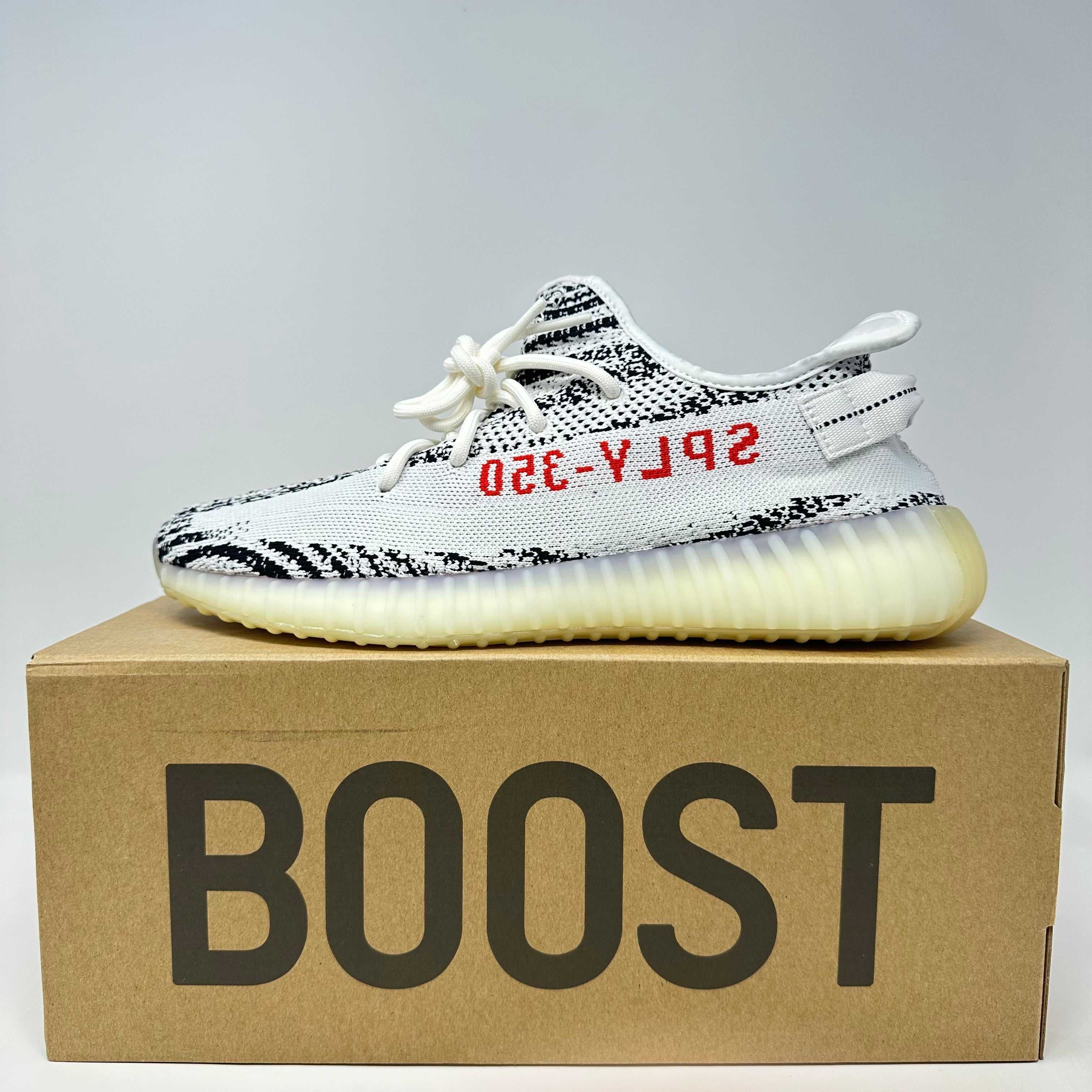 adidas Yeezy Boost 350 V2 Zebra sneaker on Boost box, brand new with all accessories included.