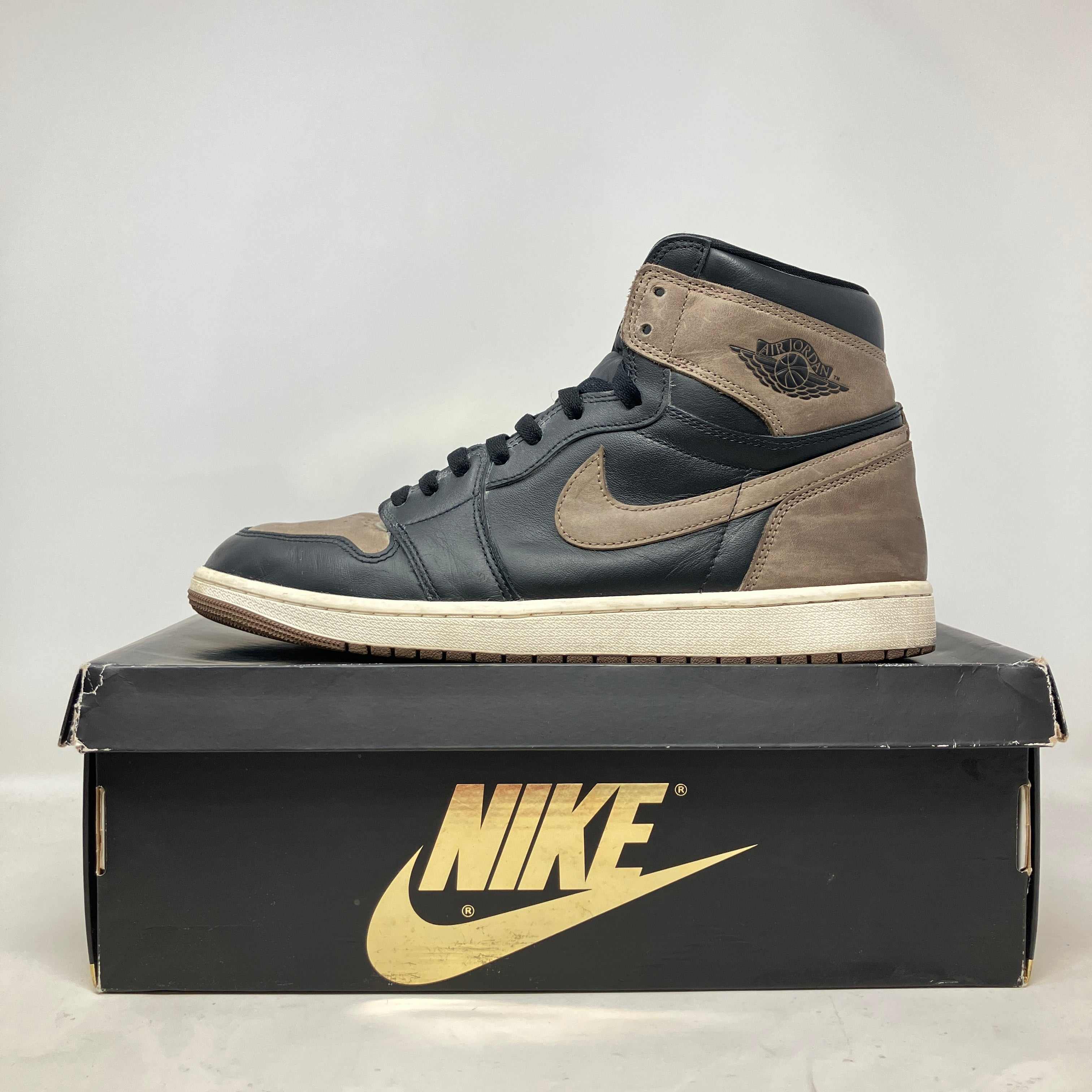 Jordan 1 Retro High OG Palomino men's high-top sneaker in black and brown on a Nike box, pre-owned with accessories included