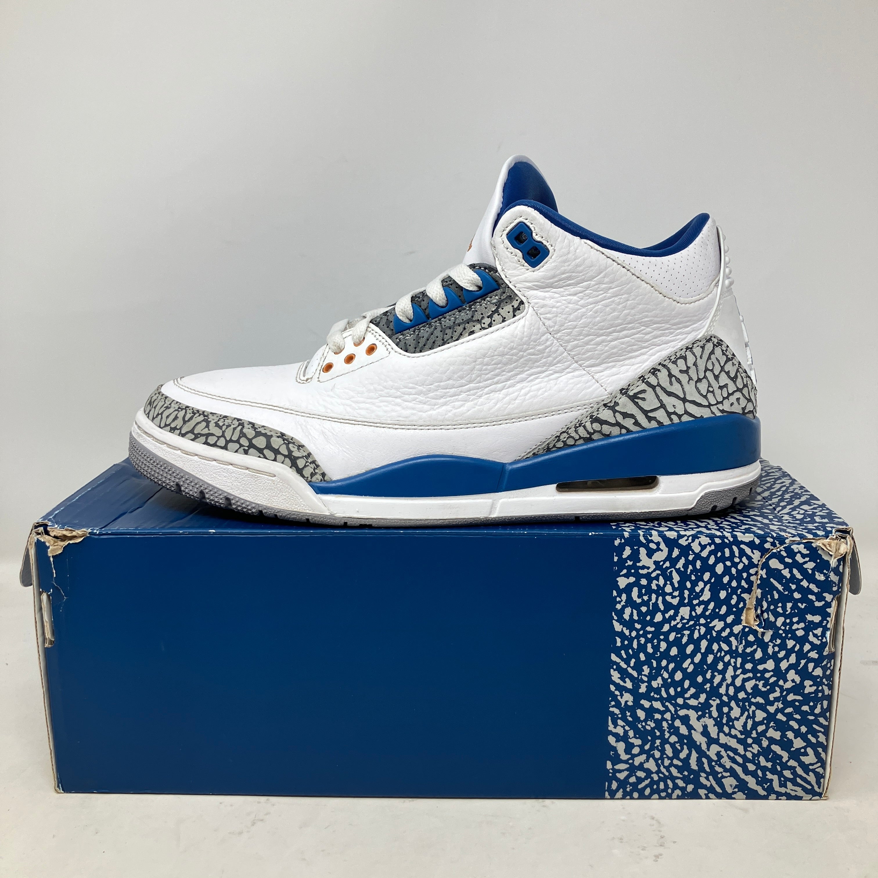 Jordan 3 Retro Wizards white and blue sneaker with elephant print detailing on original box, pre-owned condition