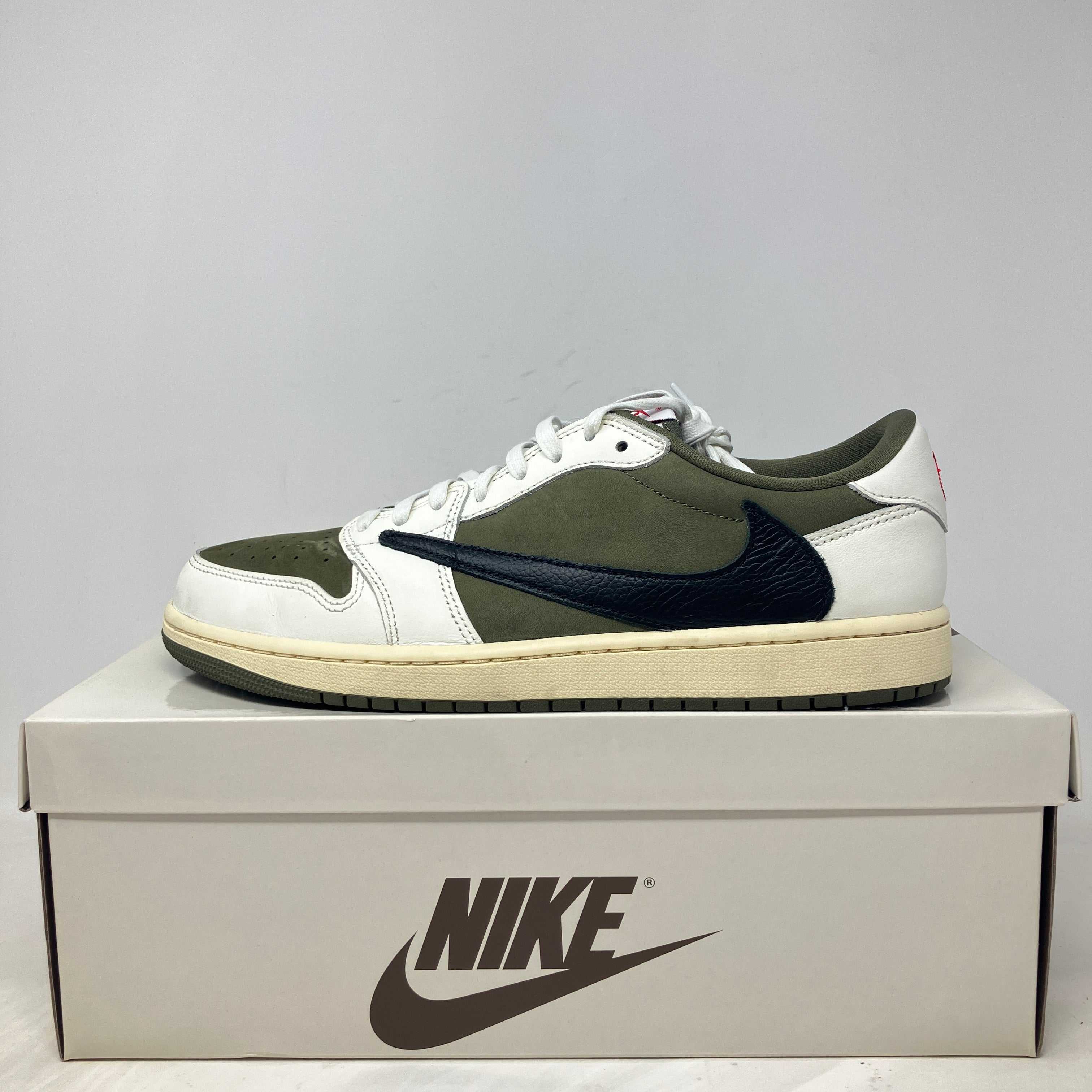 Jordan 1 Retro Low OG Travis Scott sneaker in medium olive on Nike box, pre-owned with accessories