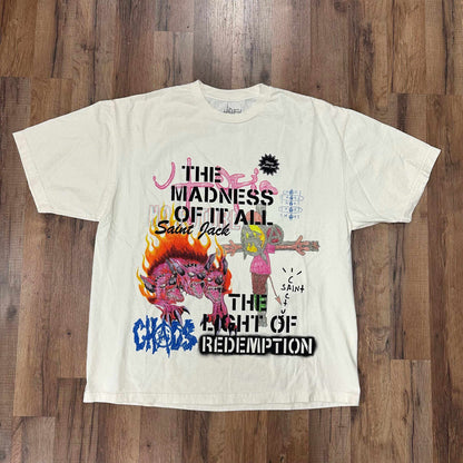 White Travis Scott Utopia x St Michael 3A Tee with graphic text and colorful illustrations laid flat on wooden floor