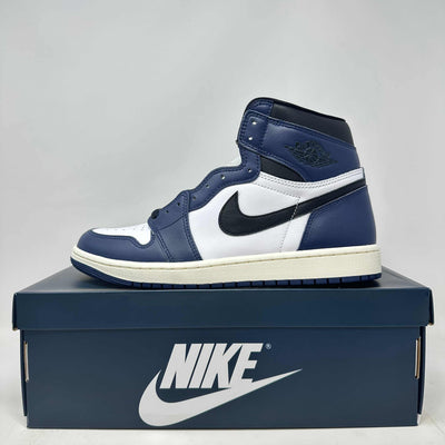 Jordan 1 Retro High basketball shoe in midnight navy, white leather with black swoosh and logo detailing on a navy box.