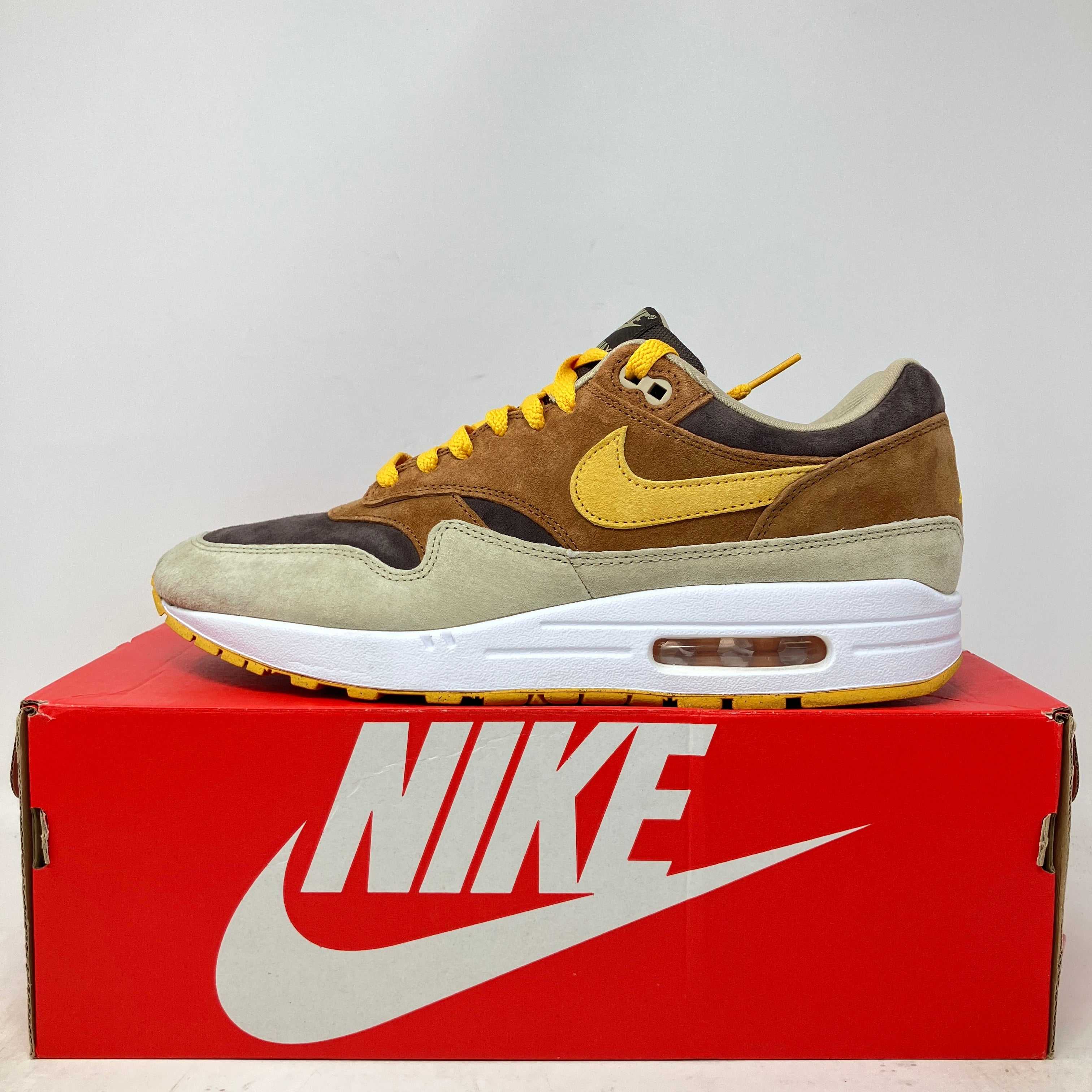 Nike Air Max 1 PRM sneaker in duck pecan and yellow ochre on red Nike box