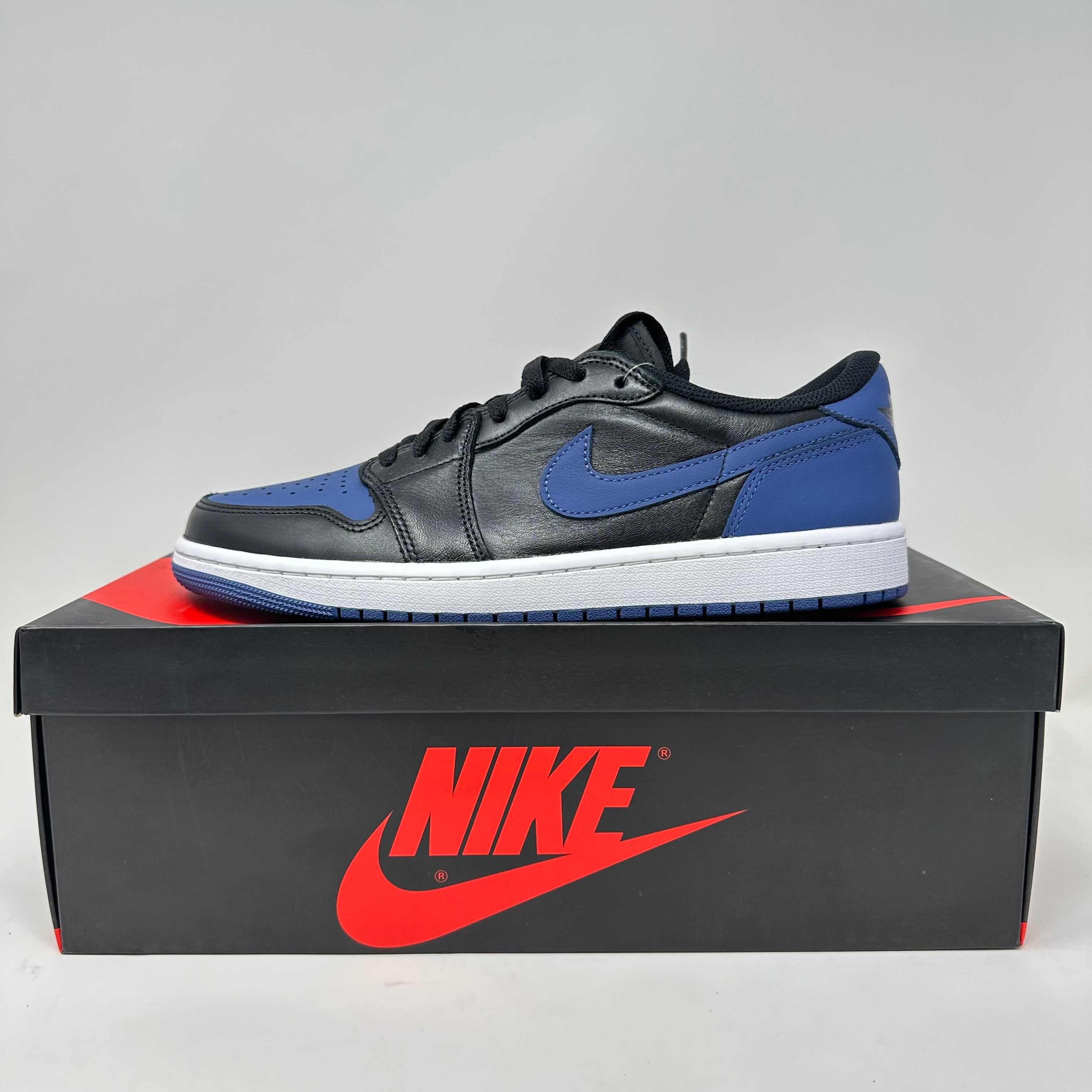 Jordan 1 Retro Low OG Mystic Navy sneaker in black and blue on Nike box, brand new with accessories included