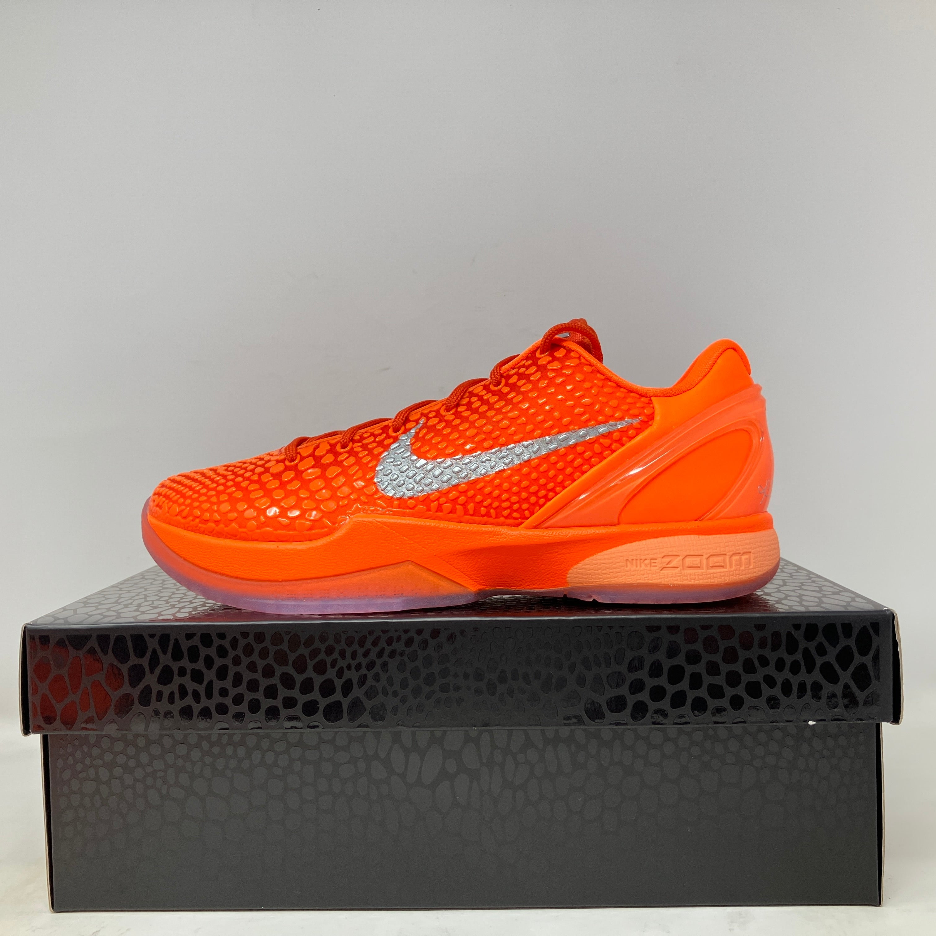 Nike Kobe 6 Protro Total Orange basketball shoe in brand new condition on a black textured shoebox