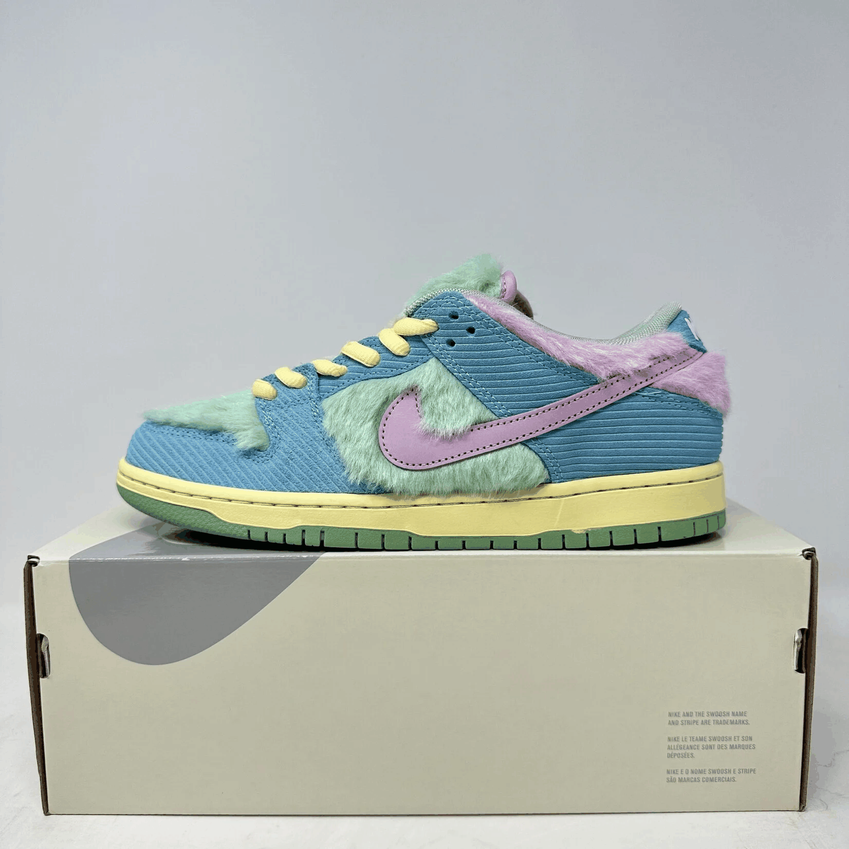 Nike SB Dunk Low Verdy Visty sneaker in blue, green, and purple with yellow laces, brand new on a box
