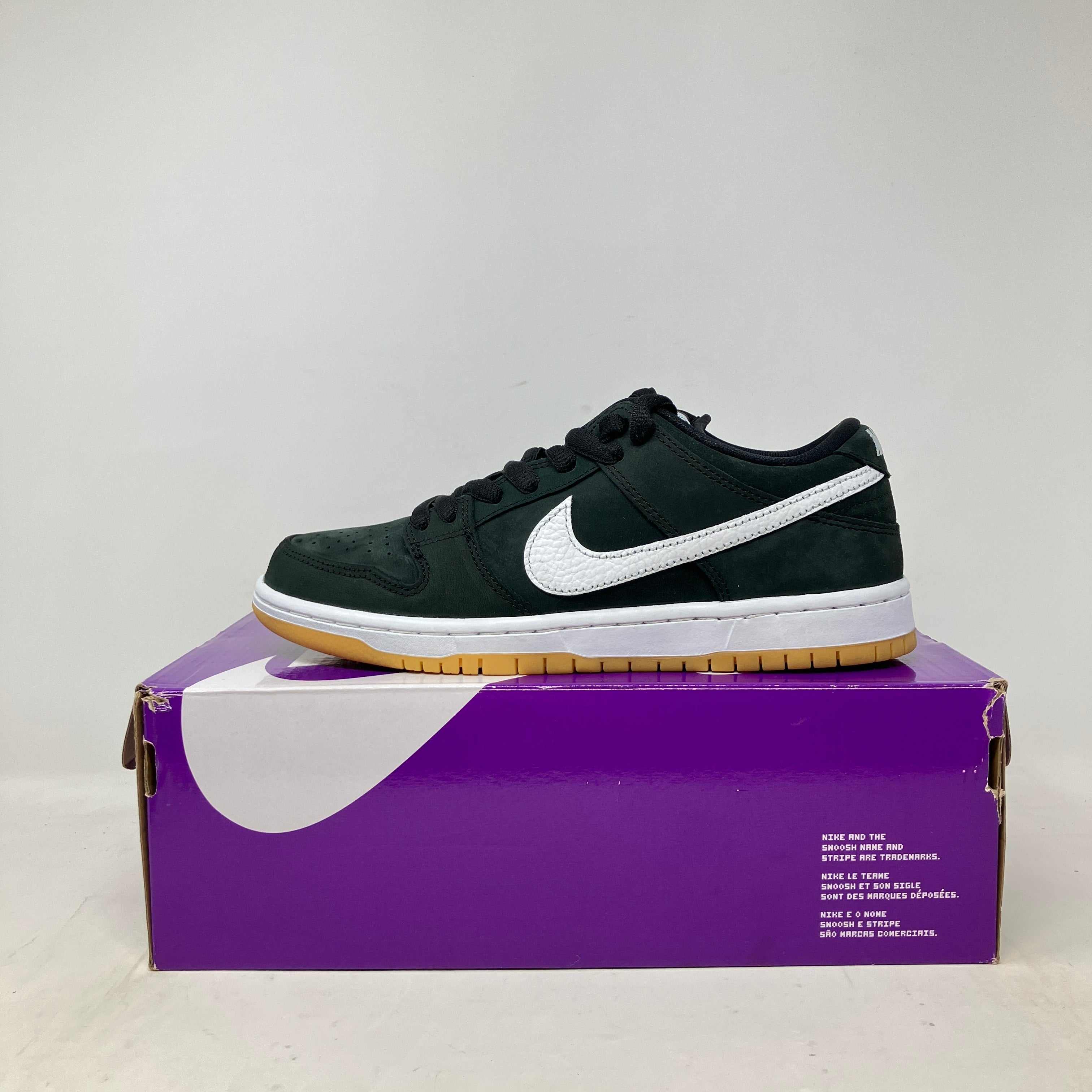 Nike SB Dunk Low Pro Black Gum on purple box, pre-owned condition, accessories included.