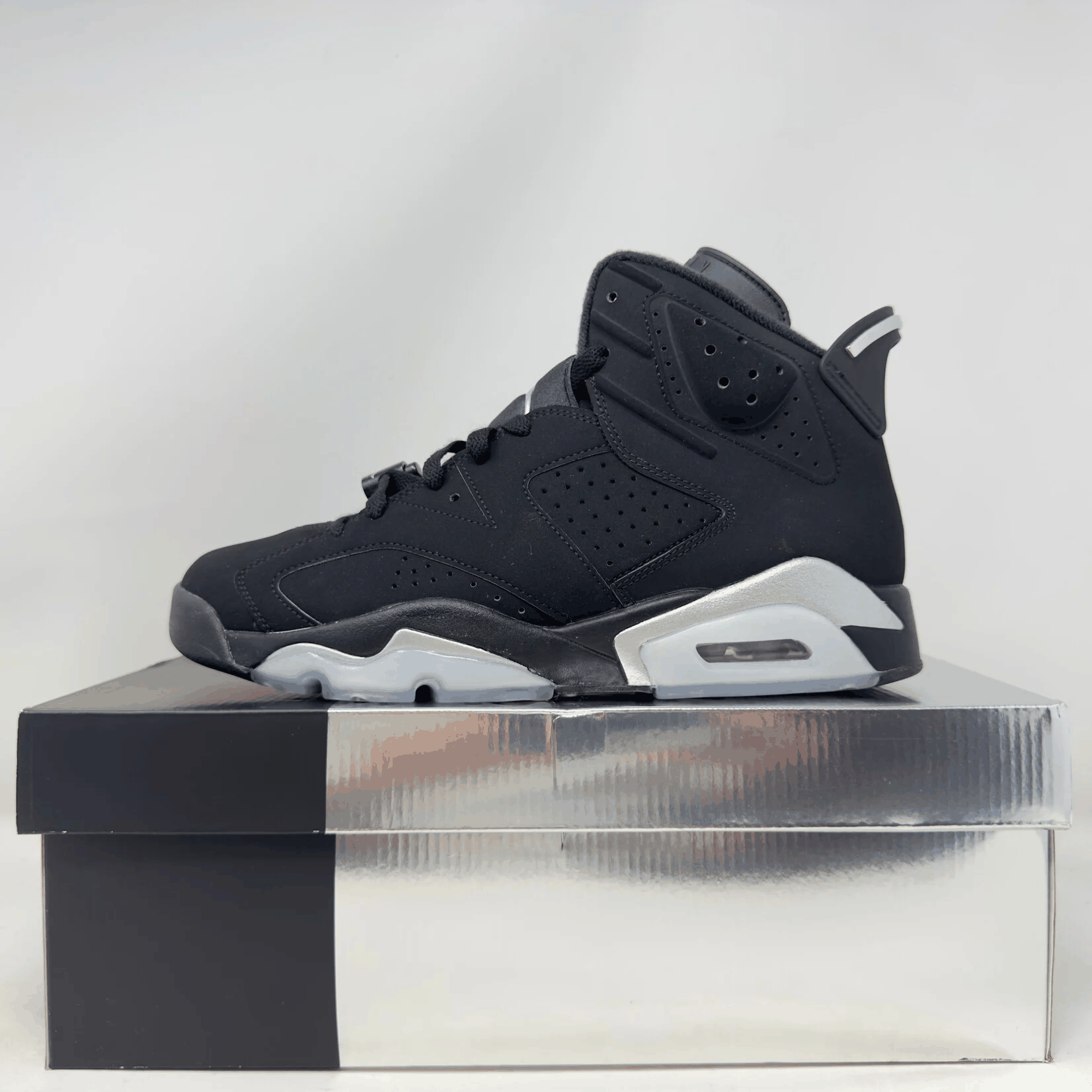 Black Jordan 6 Retro Chrome sneaker on its original pre-owned box with all accessories included