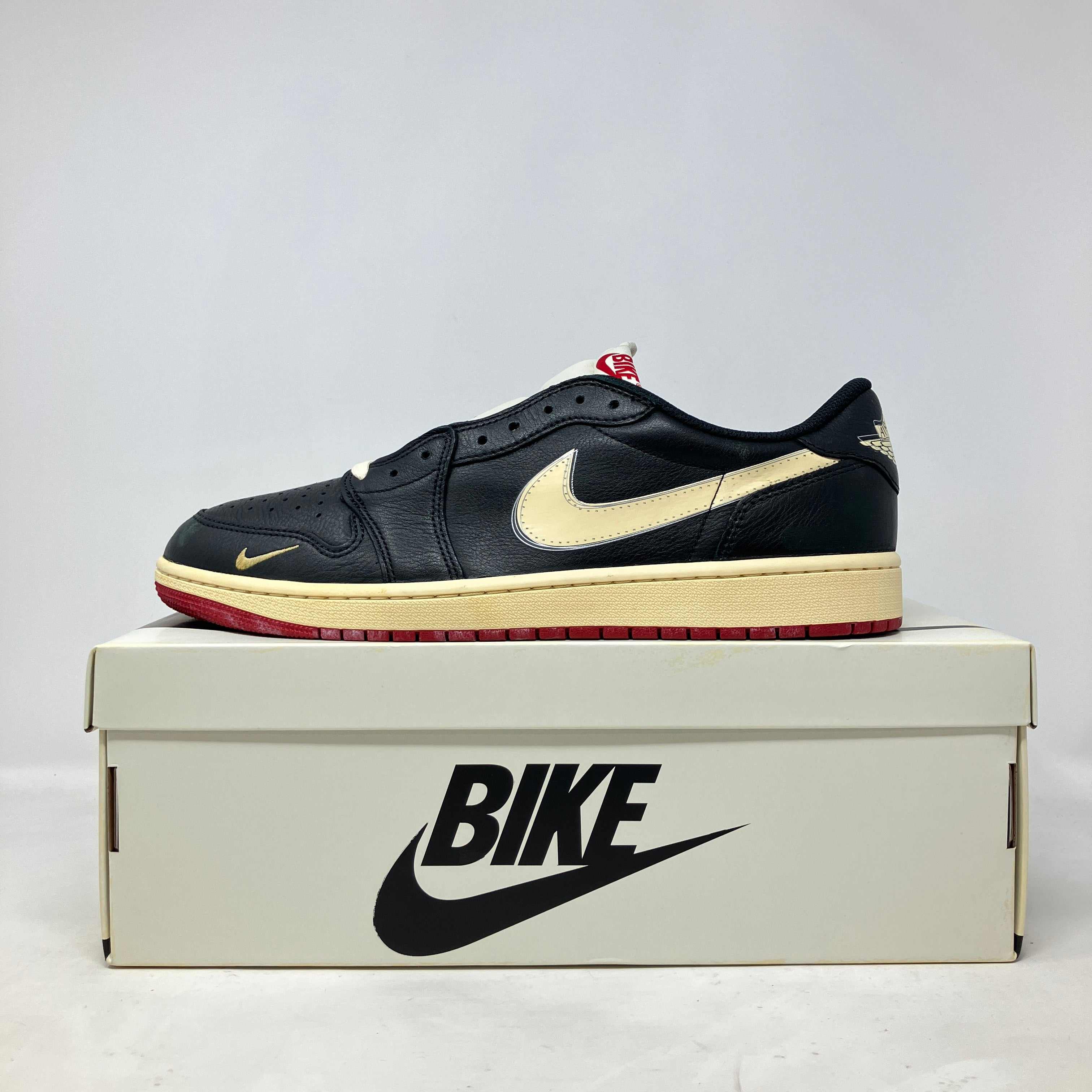 Jordan 1 Retro Low OG Nigel Sylvester Better With Time black and cream sneaker on Bike shoe box, brand new condition