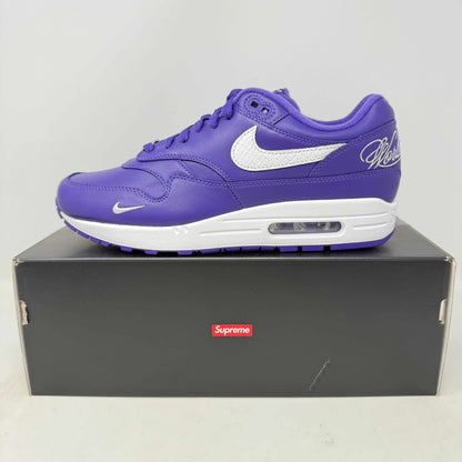 Nike Air Max 1 '87 SP Supreme Varsity Purple sneaker with white Nike swoosh on black Supreme box