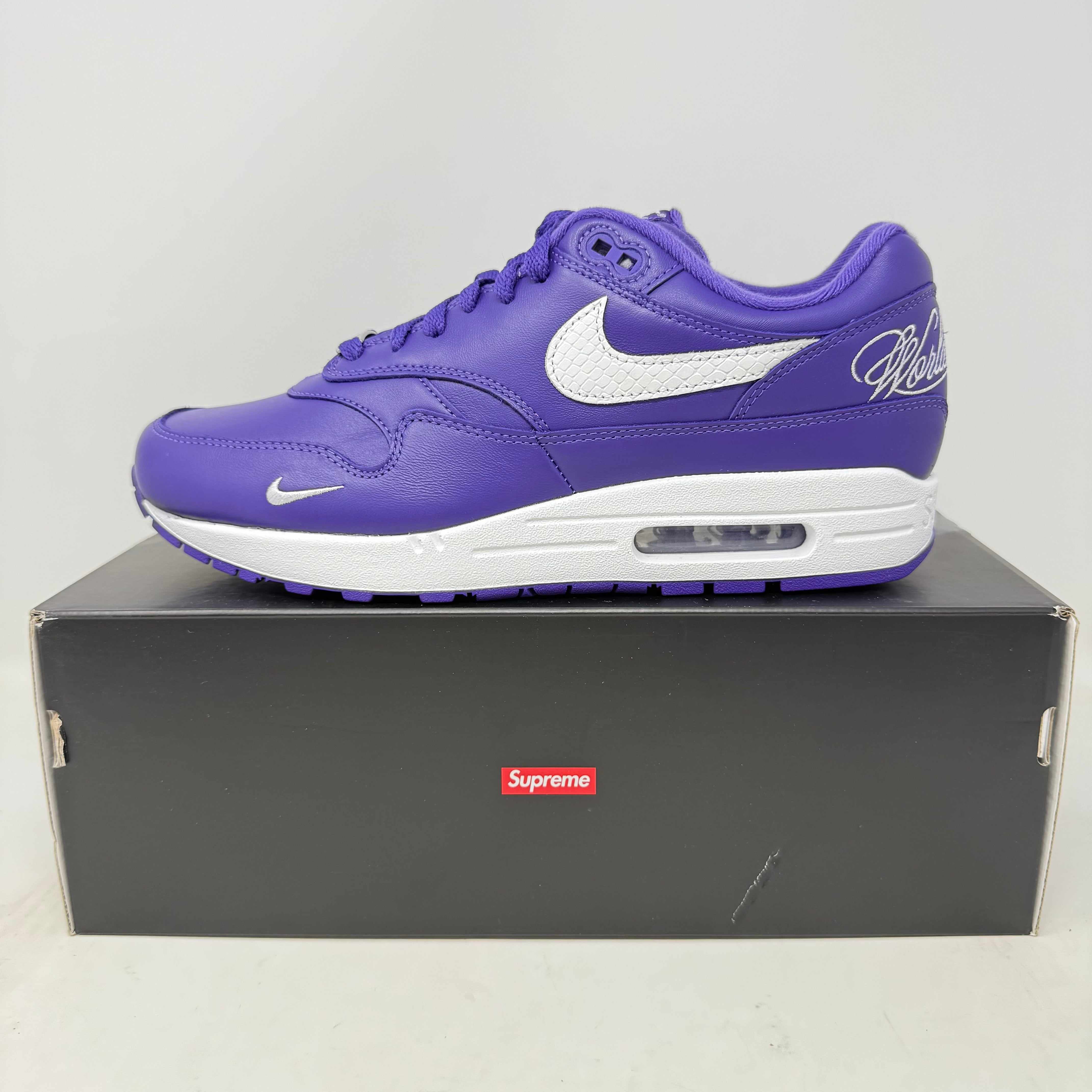 Nike Air Max 1 '87 SP Supreme Varsity Purple sneaker with white Nike swoosh on black Supreme box