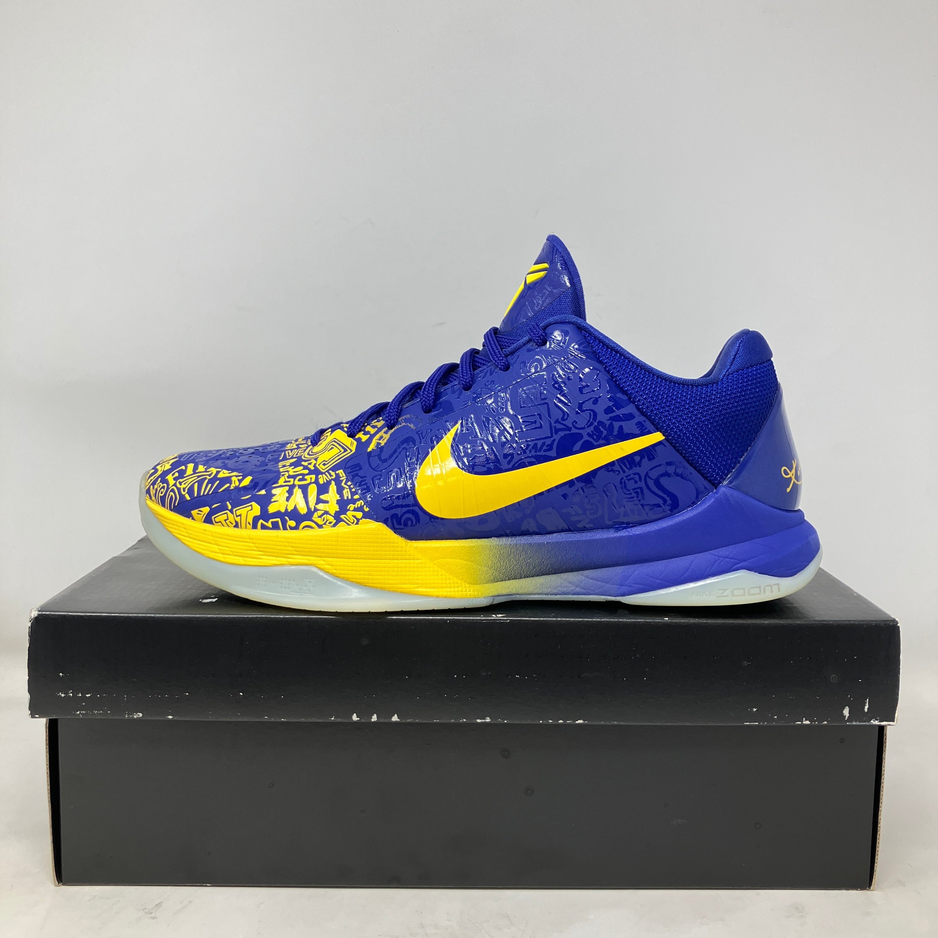 Nike Kobe 5 Protro 5 Rings 2020 blue and yellow basketball shoe side view on black box, pre-owned with all accessories included