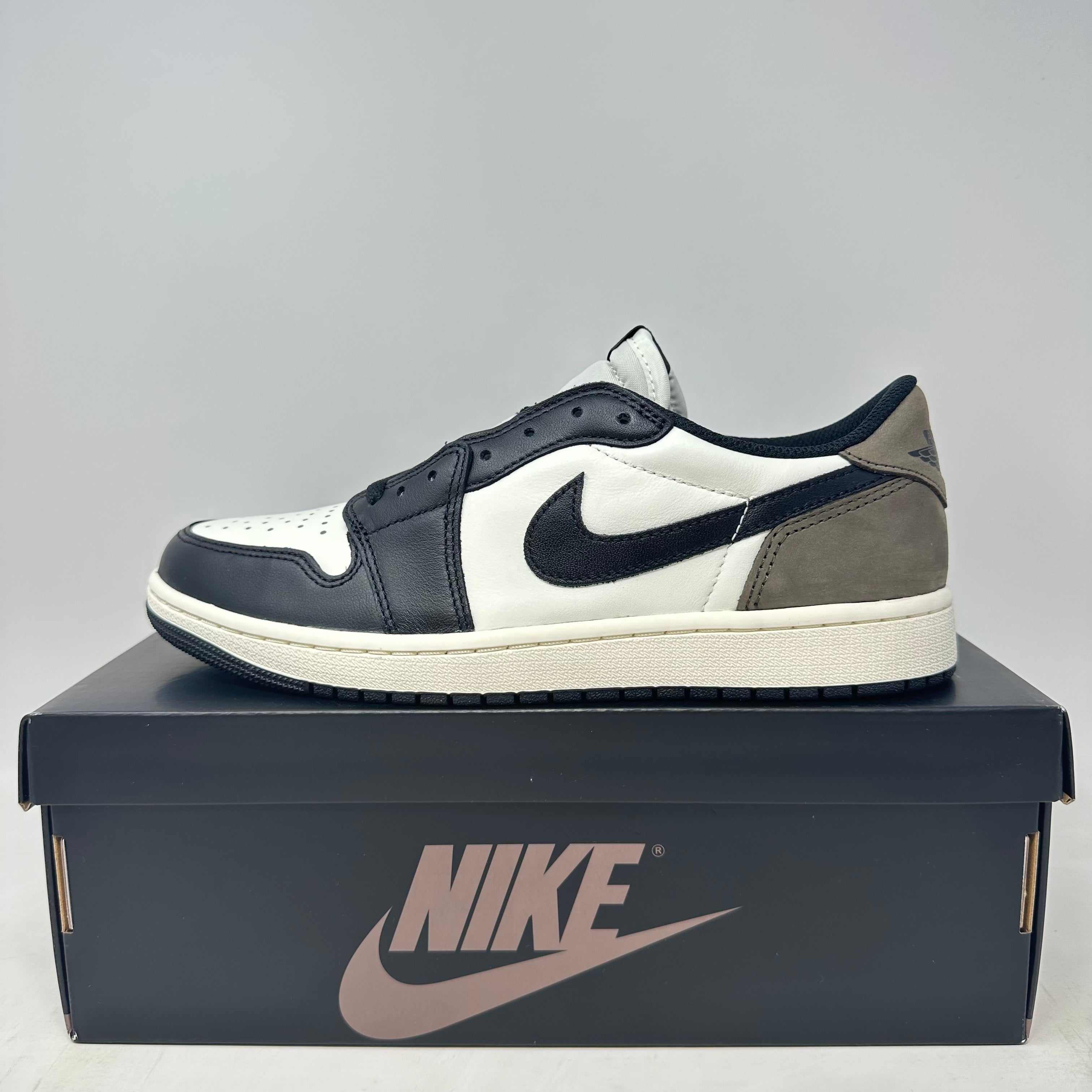 Jordan 1 Retro Low OG Mocha sneaker in black, white, and mocha colors displayed on Nike shoebox, brand new with all accessories included