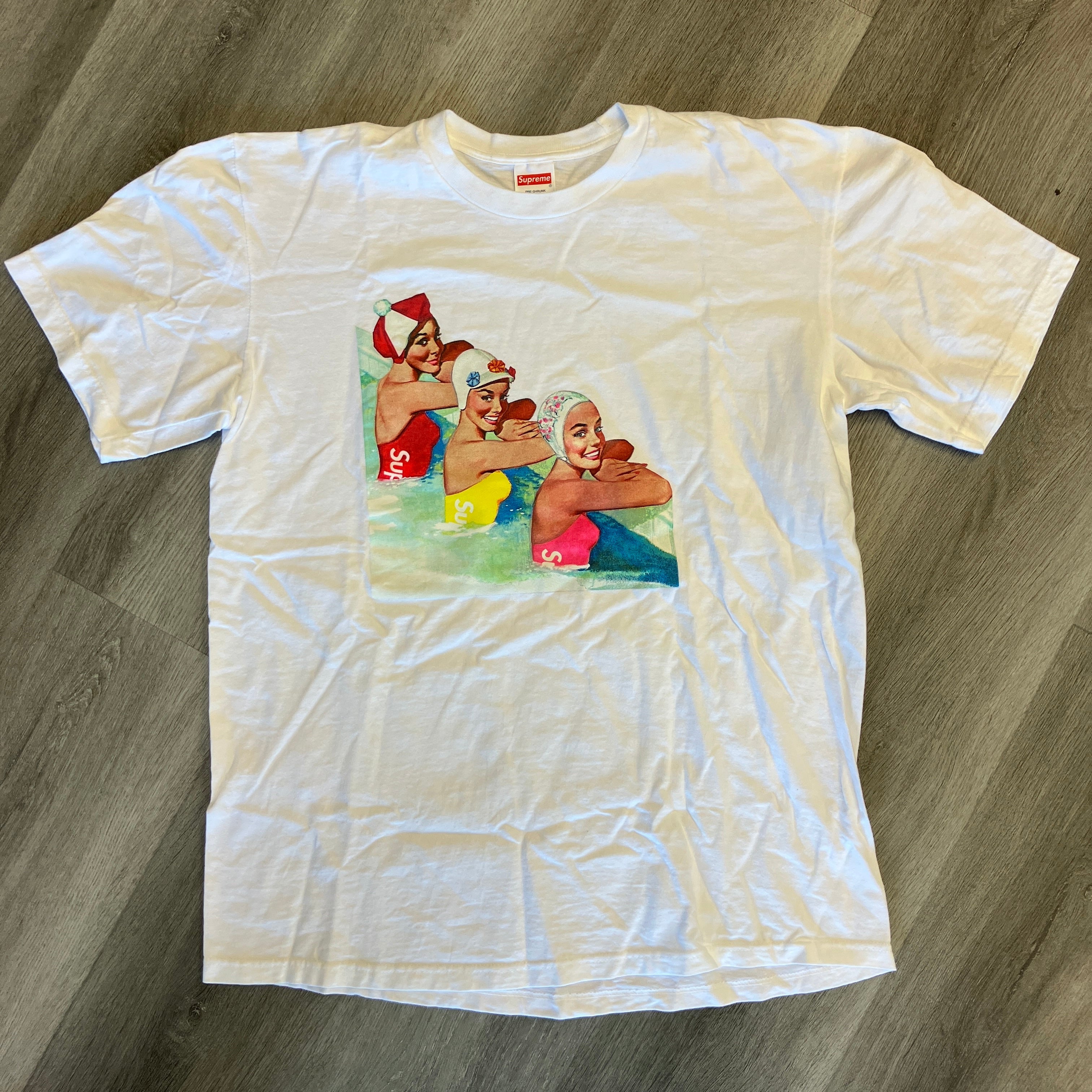White Supreme Swimmers Tee featuring graphic of three swimmers, brand new with 21" pit to pit and 30" length