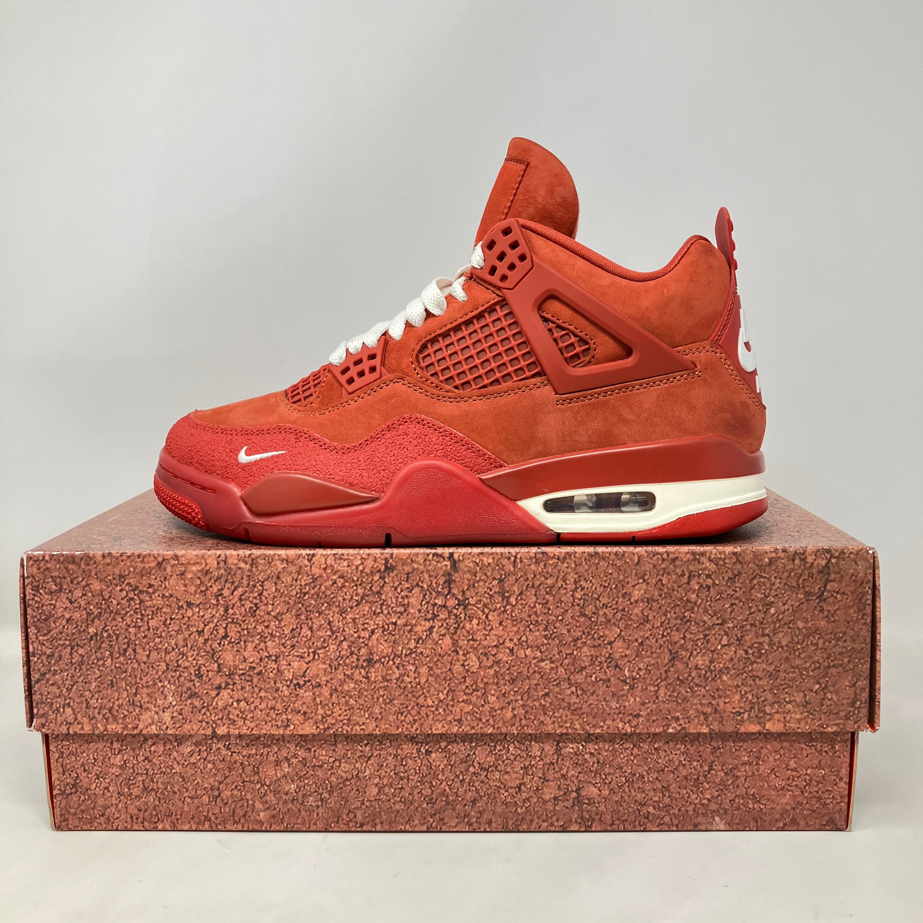 Air Jordan 4 Retro Nigel Sylvester Brick by Brick sneaker in red suede on matching box, pre-owned with accessories included
