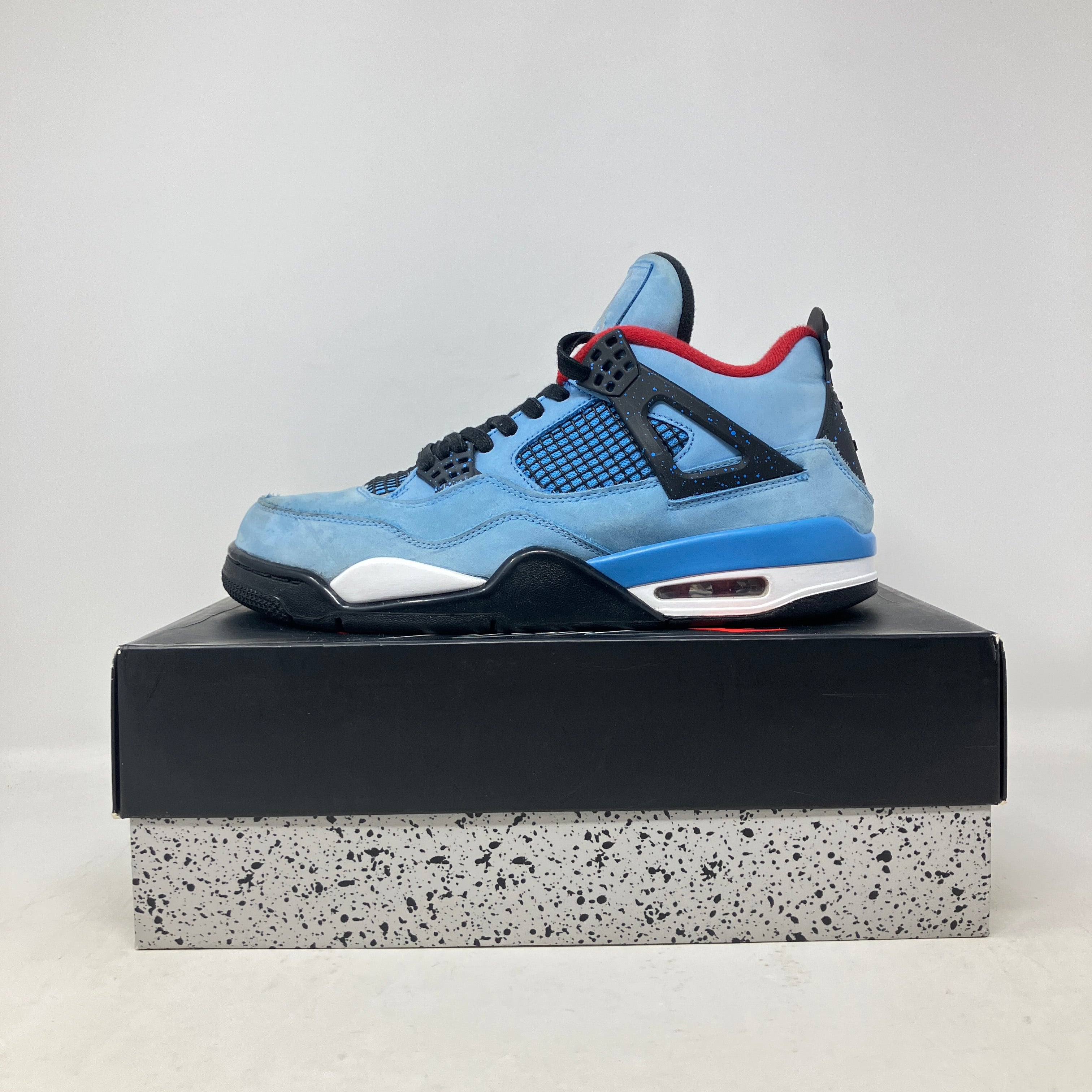 Jordan 4 Retro Travis Scott Cactus Jack sneakers, pre-owned, blue color, displayed on box.