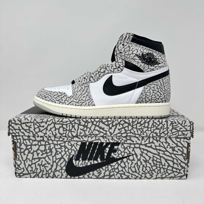 Jordan 1 Retro High OG White Cement sneaker on matching Nike box, brand new with accessories included