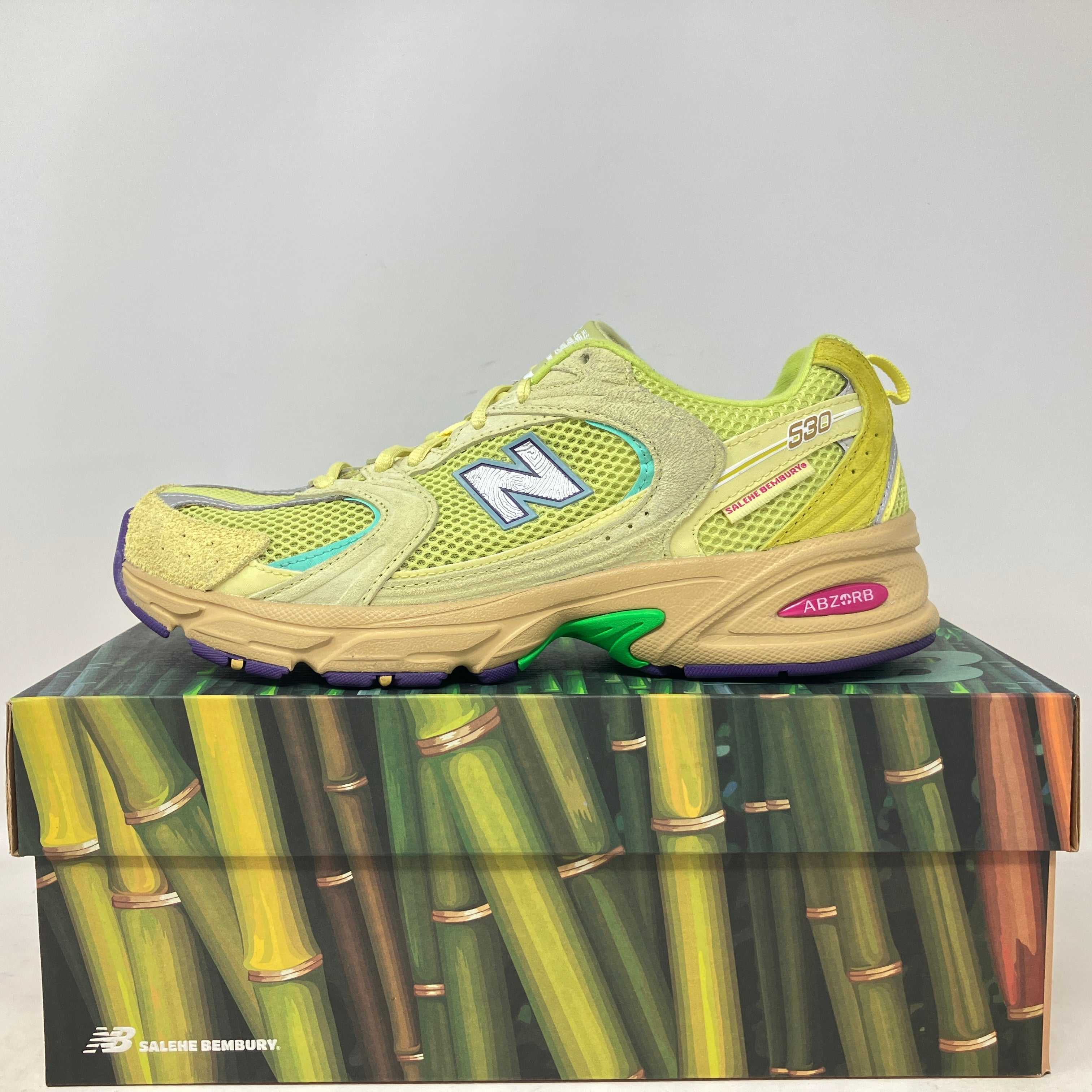 Side view of pre owned New Balance 530 Salehe Bembury Prosperity sneaker on bamboo-themed box with all accessories included
