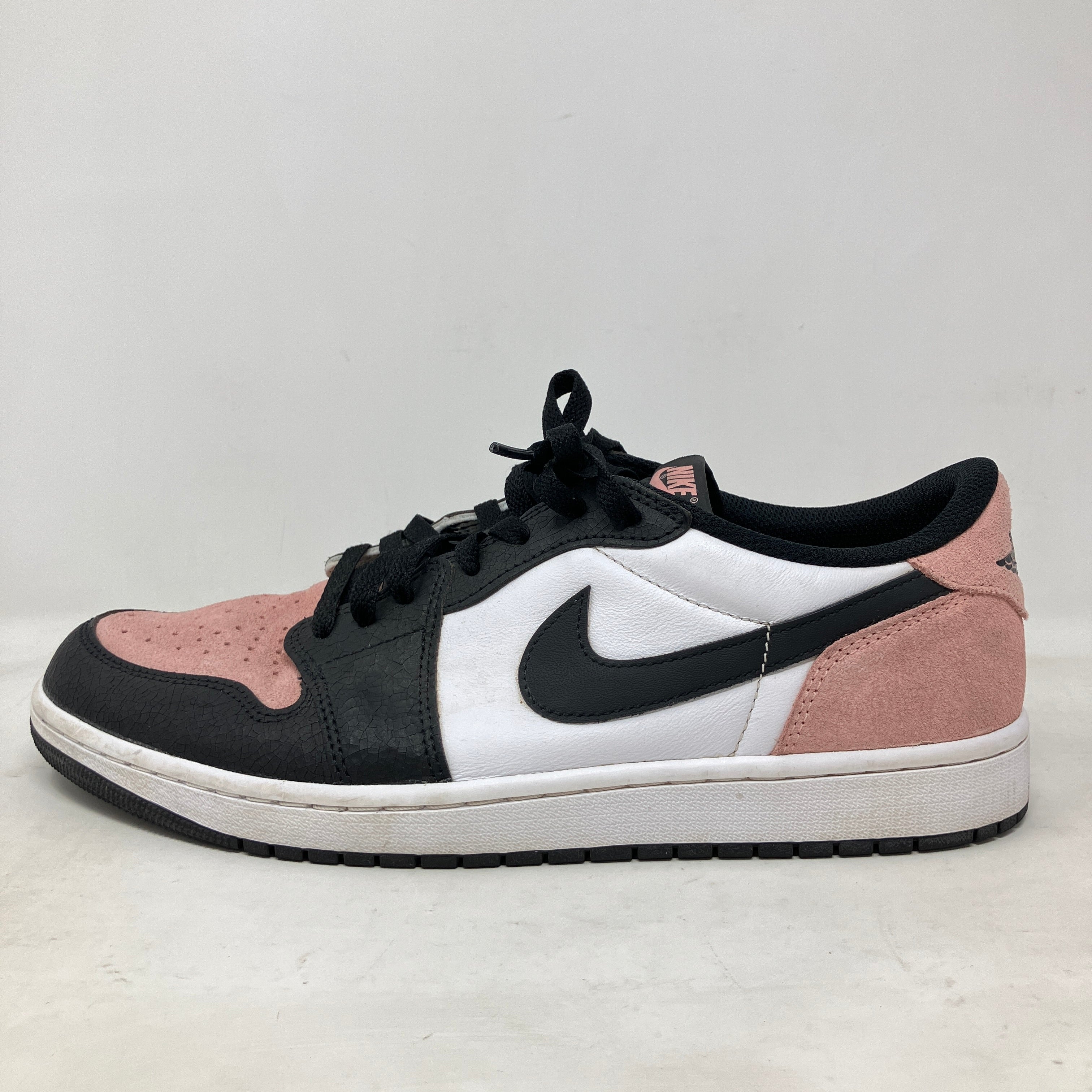 Side view of pre-owned Jordan 1 Low OG Bleached Coral sneaker with black, white, and coral suede detailing and extra laces included