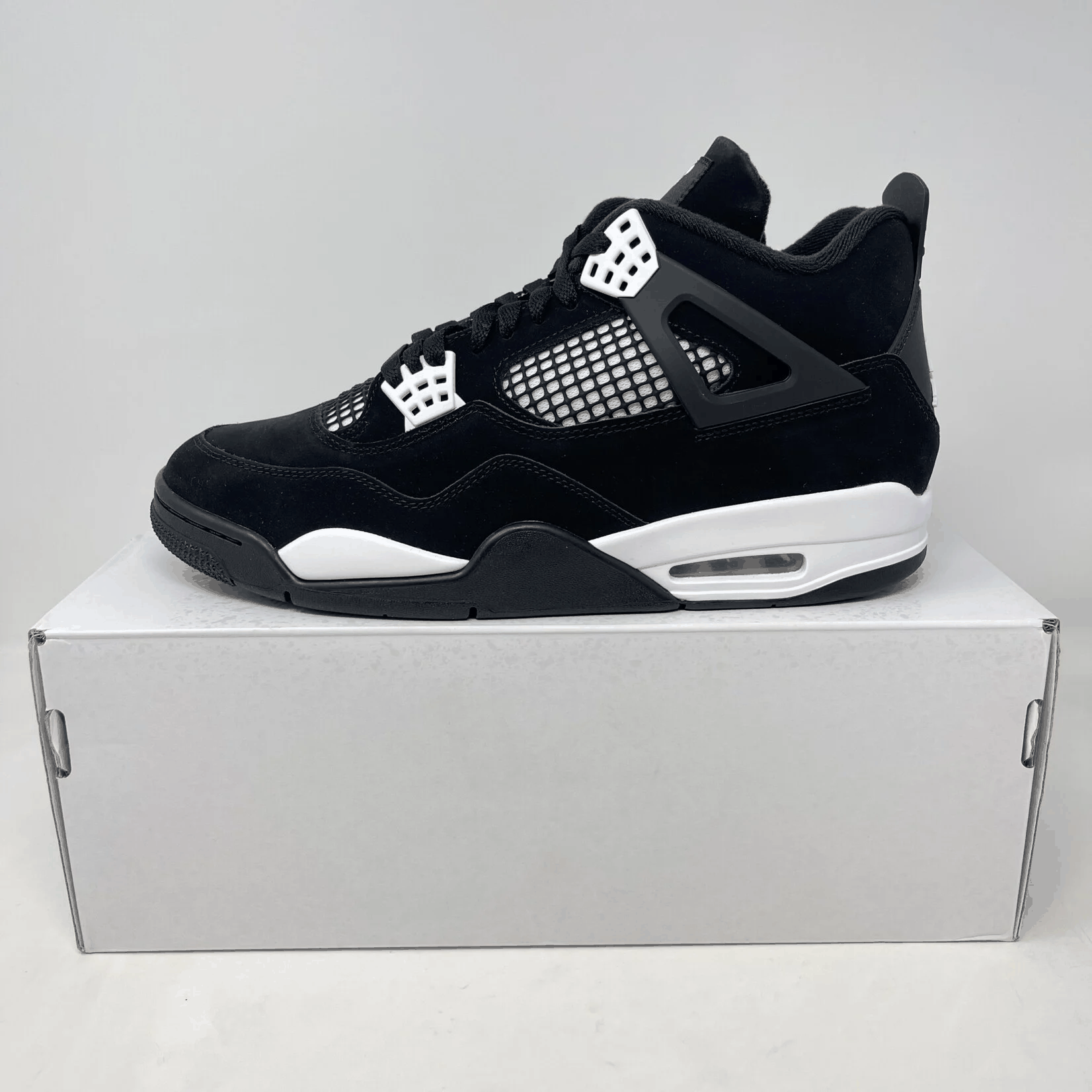Jordan 4 Retro White Thunder sneakers, brand new with all accessories, displayed on a box.
