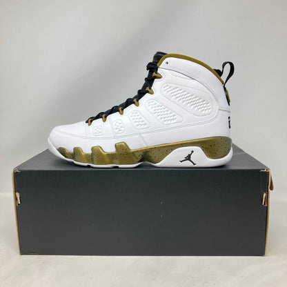 Jordan 9 Retro Statue white and gold sneaker on black box brand new with accessories