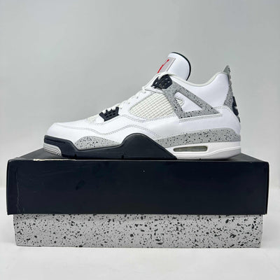 Jordan 4 Retro White Cement sneaker with a white leather upper, grey speckled overlays, mesh panels, and black accents.