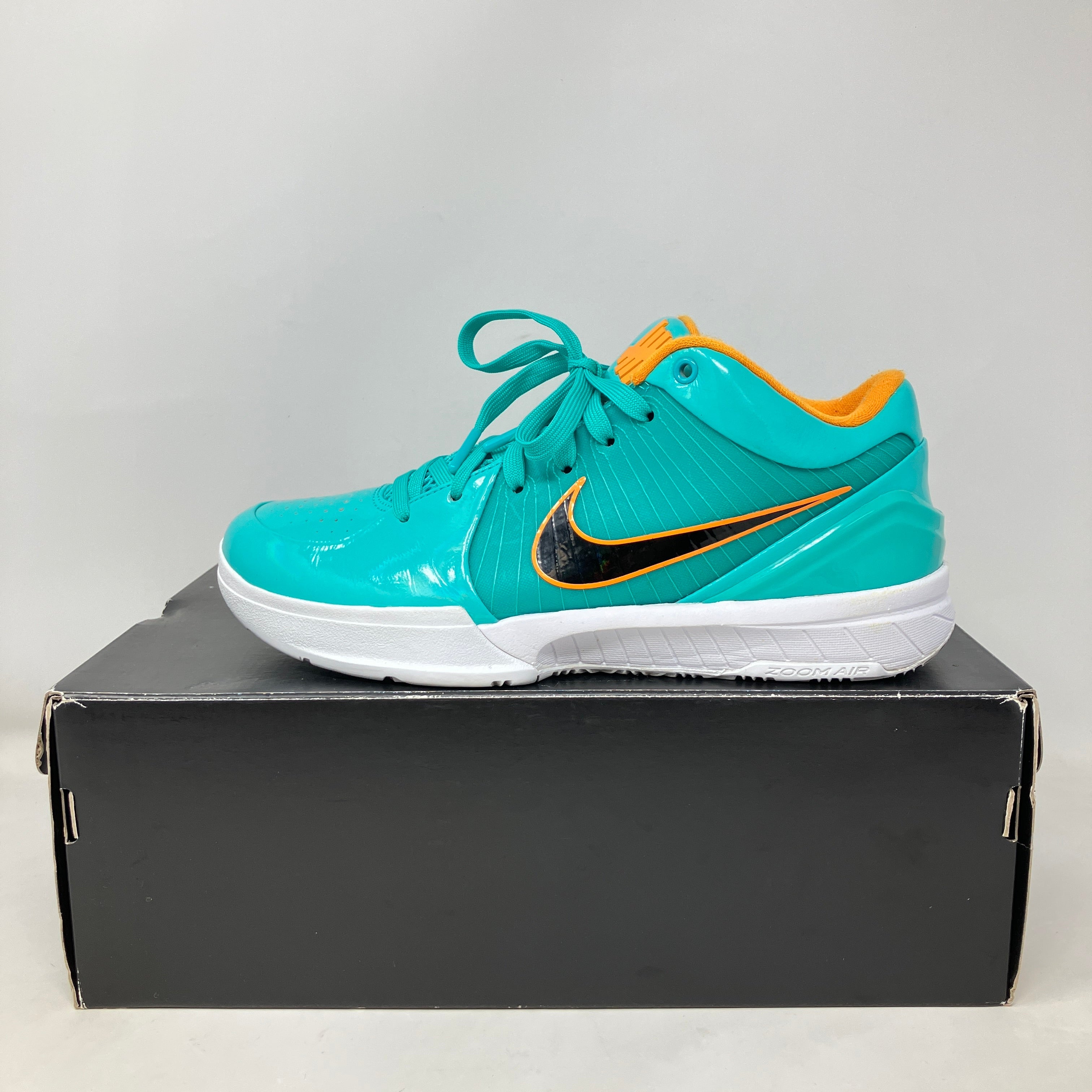 Nike Kobe 4 Protro Undefeated San Antonio Spurs teal and orange basketball shoe on black box