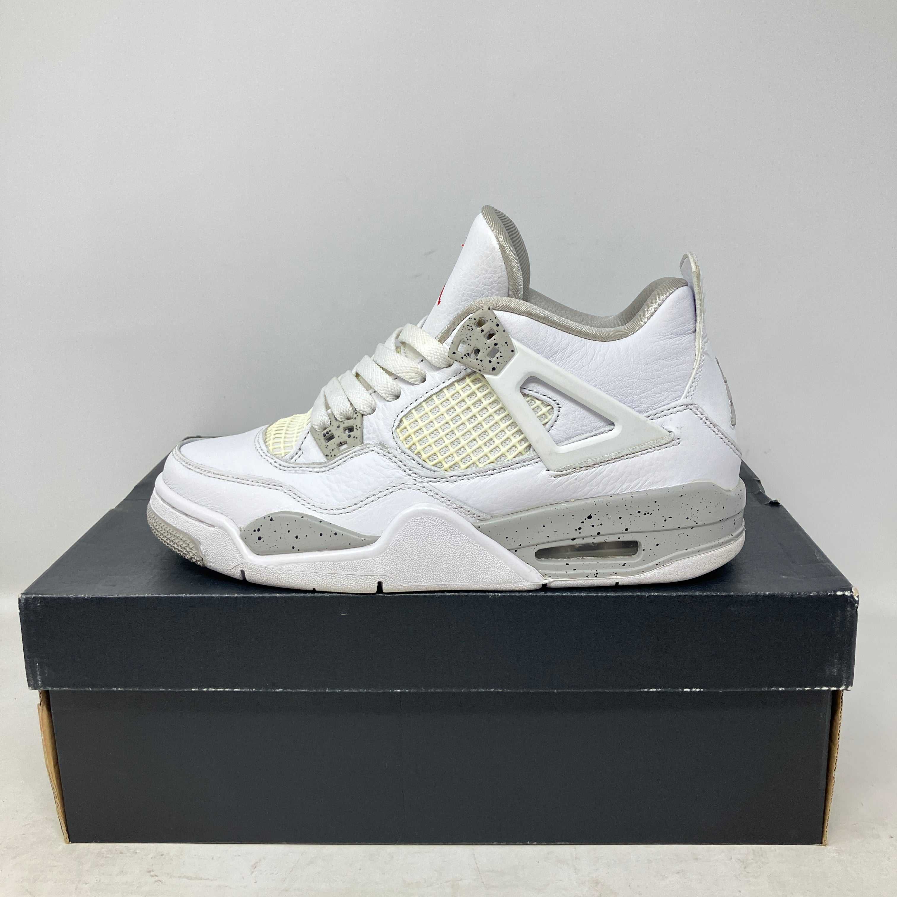 Jordan 4 Retro White Oreo GS pre-owned sneaker with white and grey speckled design on black shoe box