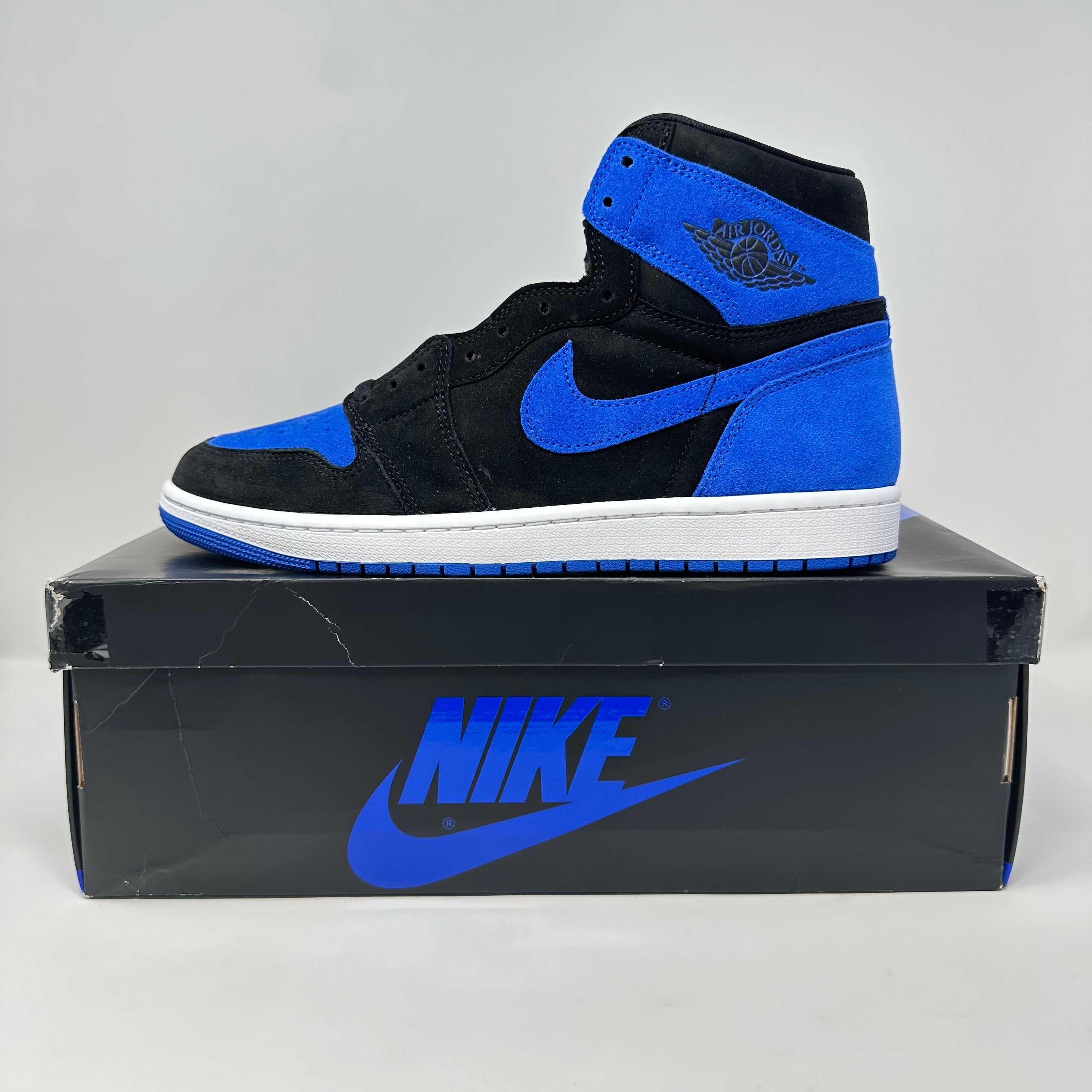 Jordan 1 Retro High OG Royal Reimagined sneaker in black and royal blue on Nike box, brand new with all accessories included.