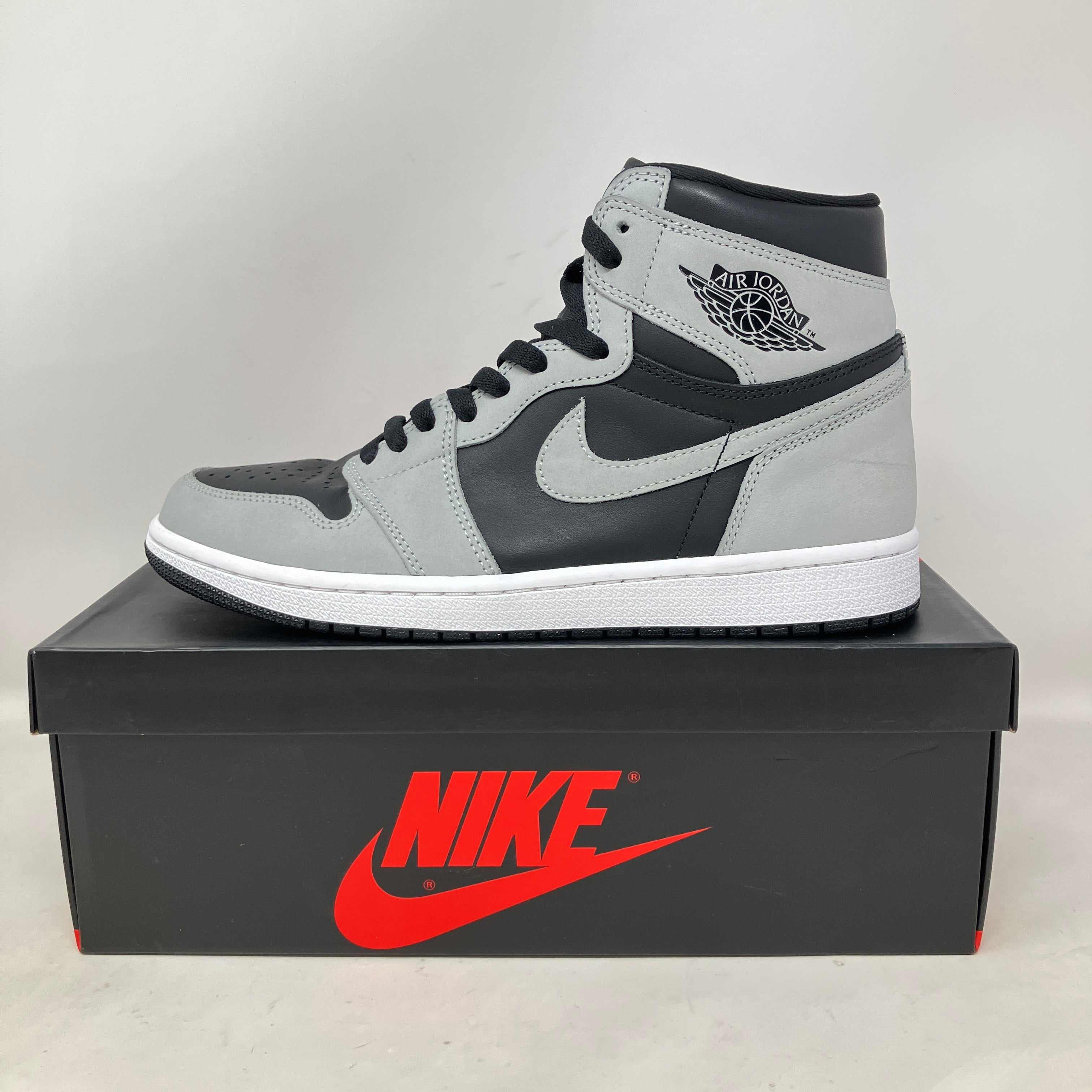 Jordan 1 Retro High Shadow 2.0 pre-owned sneaker on black Nike box with gray and black design