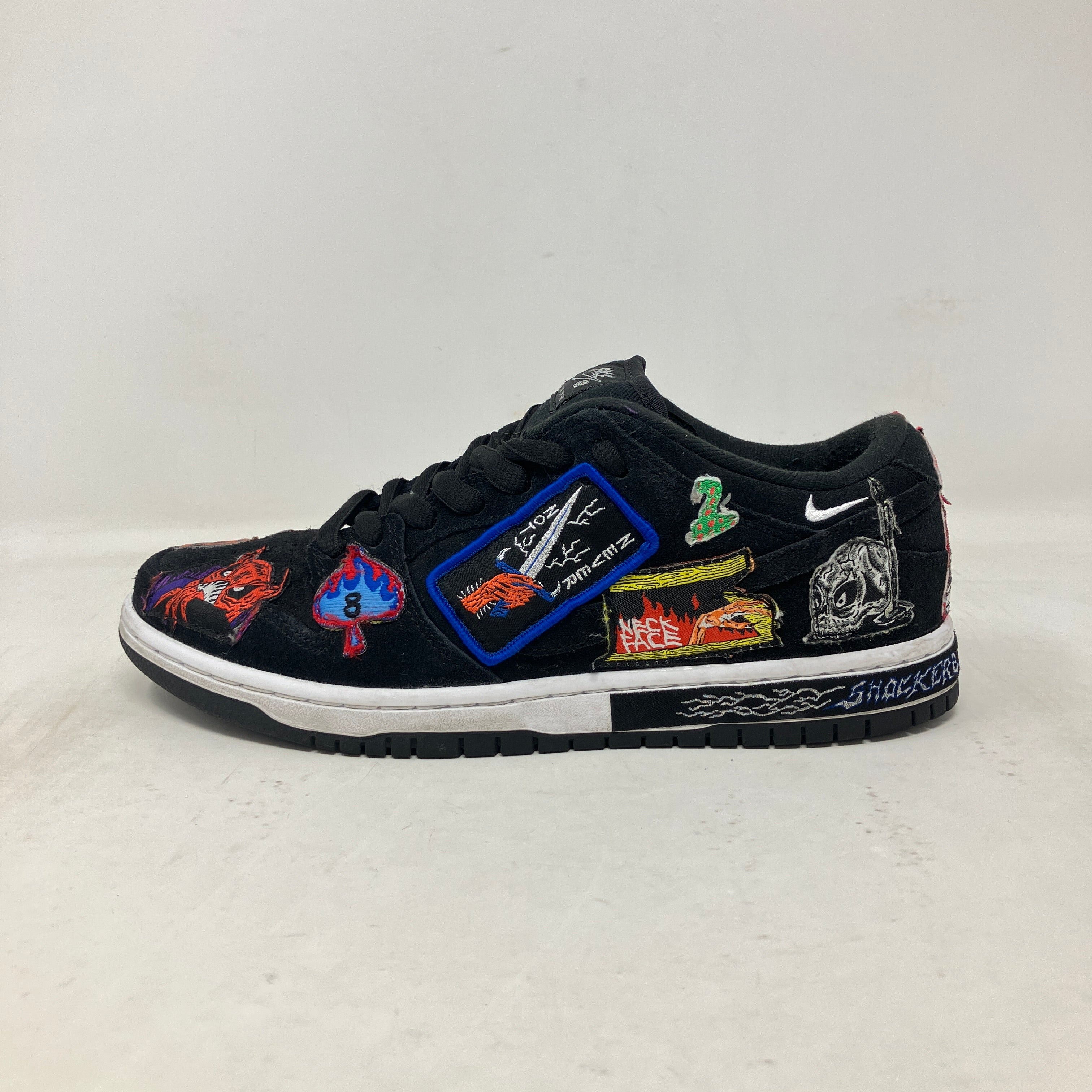Nike SB Dunk Low Pro QS Neckface sneakers, pre-owned, no box, with vibrant patches on a black base.