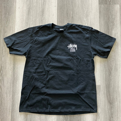 Black Stussy Built Tough Tee with white logo print, laid flat on wooden floor, brand new, 23.5in pit to pit, 32.5in length
