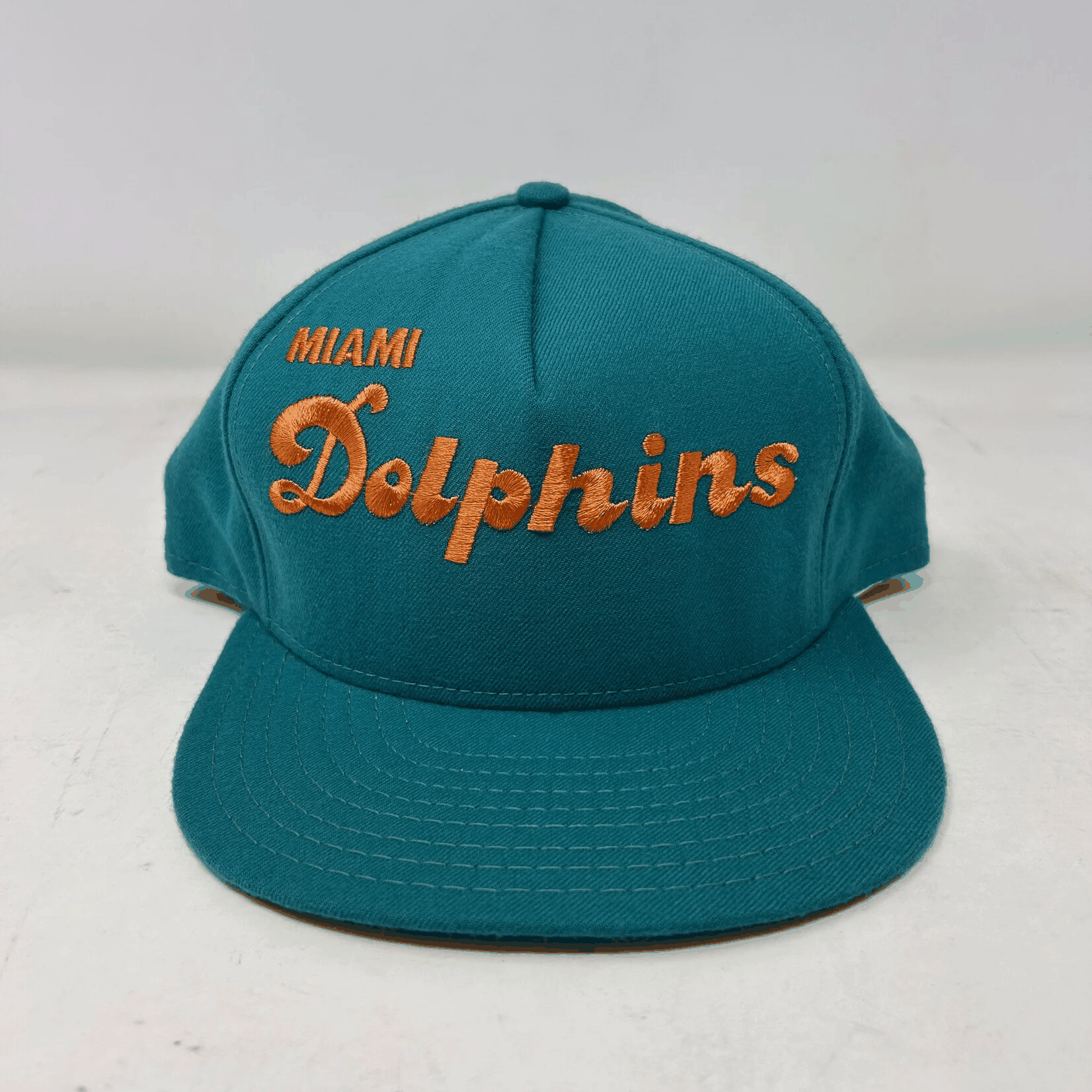 Vintage Miami Dolphins snapback cap in teal with orange embroidered logo, brand new condition