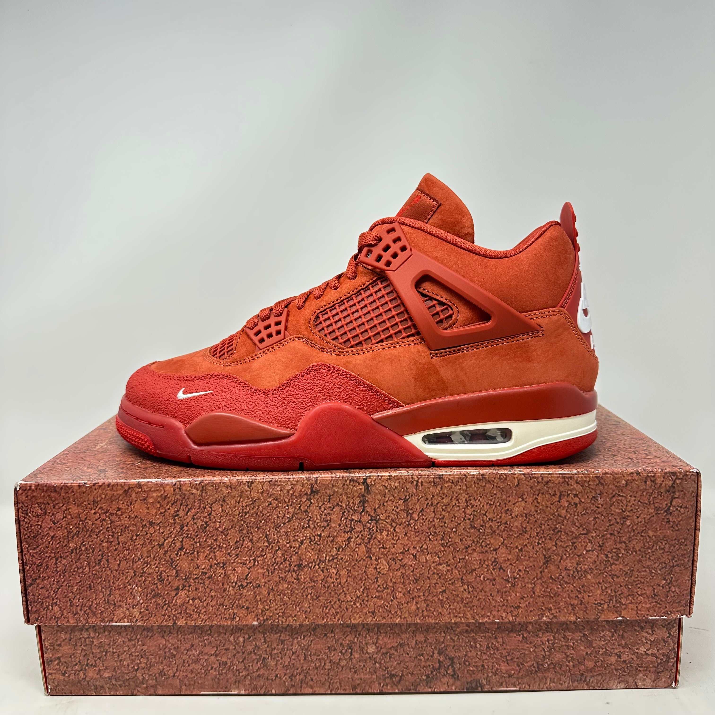 Air Jordan 4 Retro OG SP Nigel Sylvester sneaker in red with full accessories.