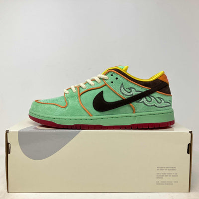 Nike SB Dunk Low sneaker in mint green suede with orange piping, black swoosh, embroidered scrollwork and red sole.
