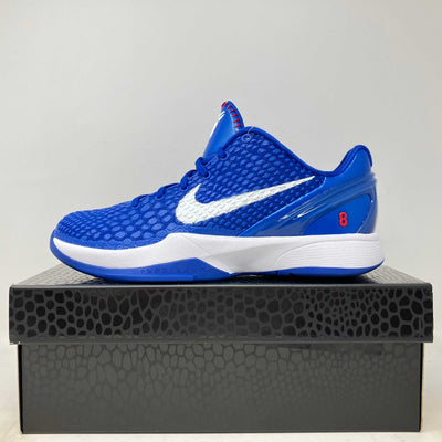 Nike Kobe 6 Dodgers basketball shoe in vivid blue textured mesh with a white Swoosh, white midsole, and red accents.